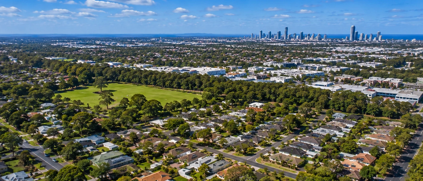 Coombabah Buyers Agent aerial view of established homes, green open space and northern Gold Coast surroundings