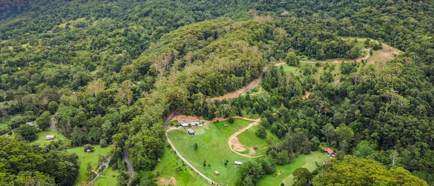 Currumbin Valley Buyers Agent aerial view of green acreage, rural homes and surrounding hinterland ranges