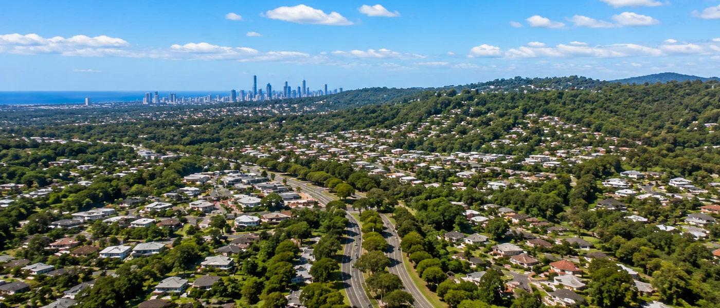 Highland Park Buyers Agent aerial view of established homes, leafy hills and western Gold Coast skyline