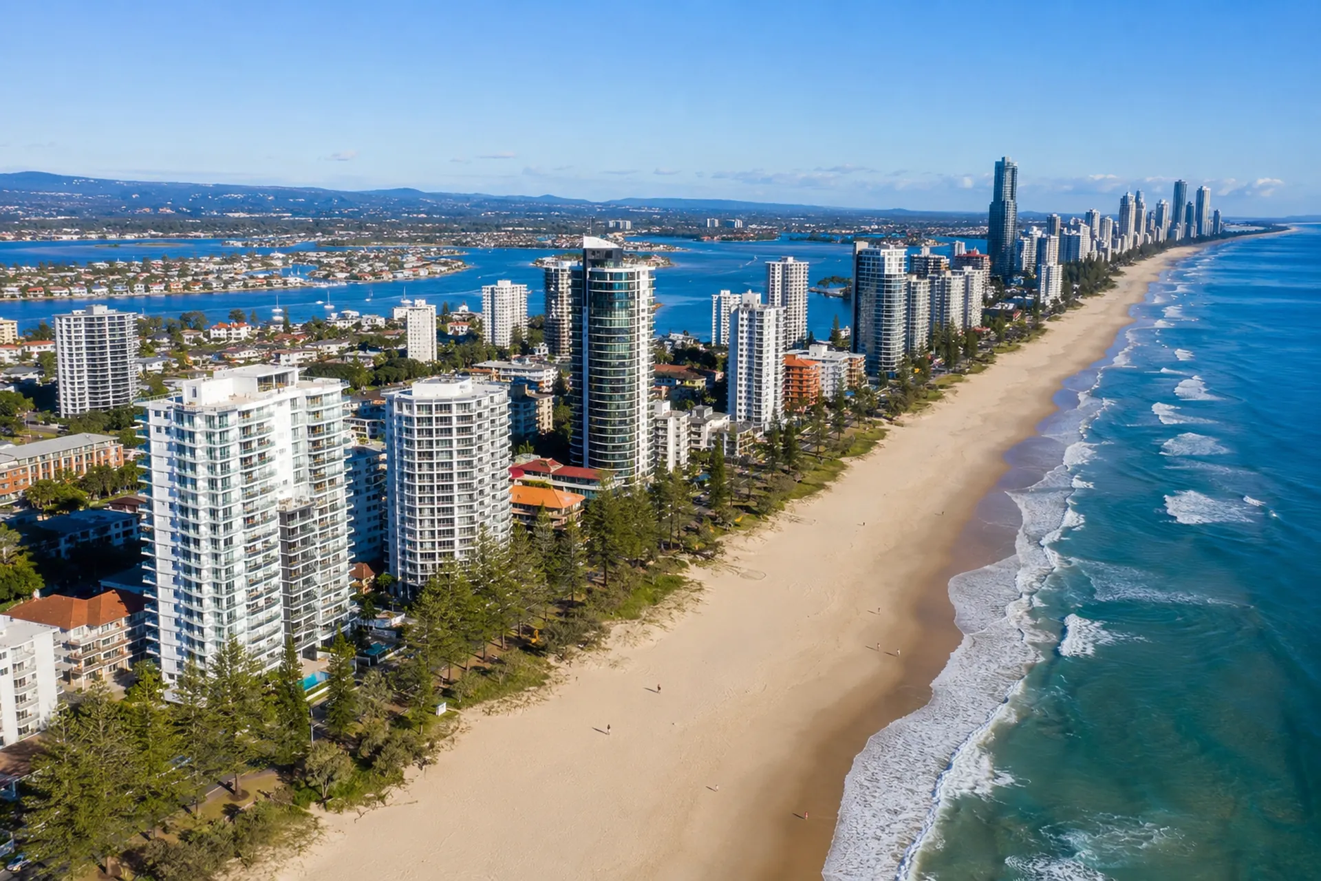 Main Beach buyers agent aerial view of beachfront apartments, coastline and the Gold Coast skyline