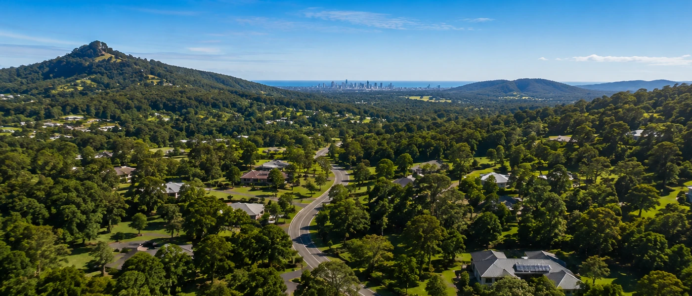 Mudgeeraba Buyers Agent aerial view of leafy homes, rolling hills and Gold Coast hinterland